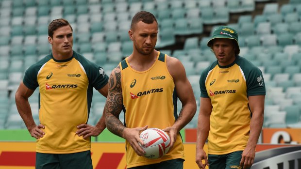 Missed the cut: Quade Cooper, centre, with Ed Jenkins, left, at Australia Sevens training at Allianz Stadium on Friday.