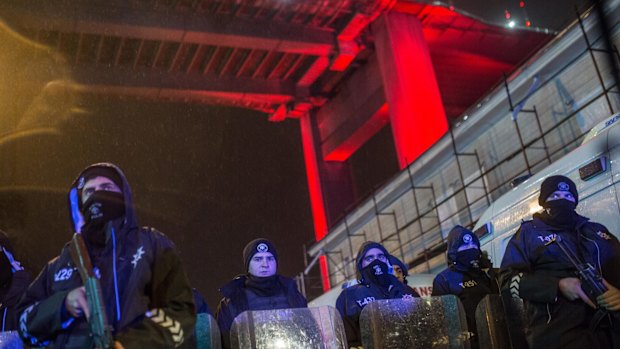 Turkish police secure the area at Ortakoy district under Bosphorus Bridge near night club Reina.