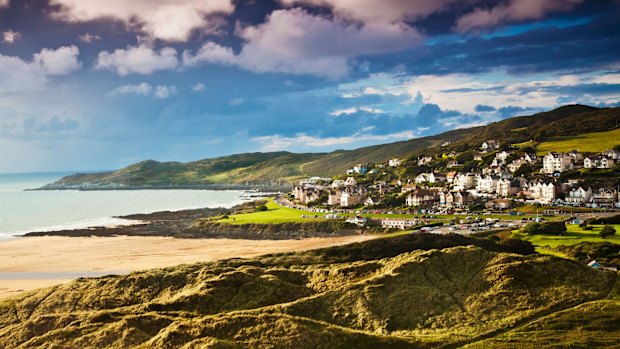 Evening light falls on the English coastal resort town of Woolacombe in Devon.