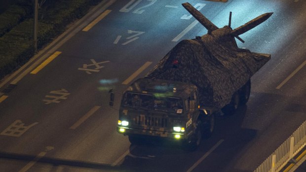 A Chinese military truck carries what appears to be a drone during rehearsals.