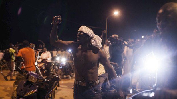 People demonstrate near the presidential palace after soldiers arrested Burkina Faso's leaders. 