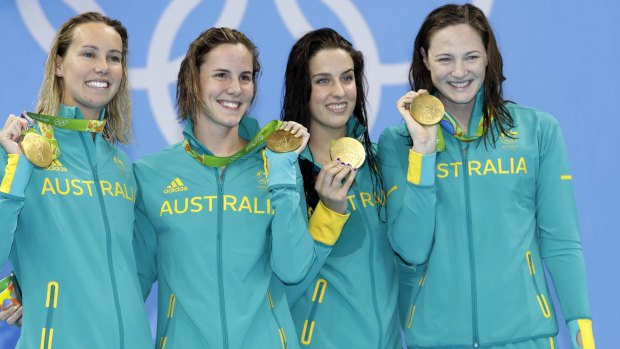Bronte Campbell, second left, and Cate Campbell, right, show off the gold medals they won on the first night in Rio.