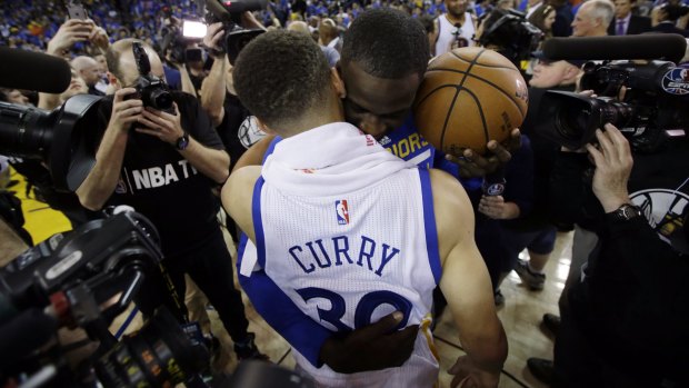 Dream come true: Stephen Curry, front, is hugged by teammate Draymond Green.