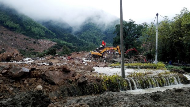 Rescuers search for survivors following a landslide in Sucun village in eastern China's Zhejiang Province in September 2016.