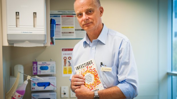 Professor Frank Bowden with a copy of his book, 'Infectious'.