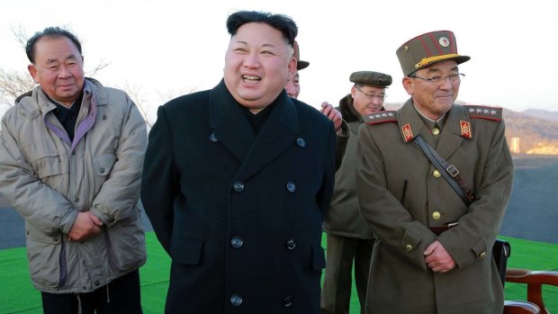 Kim Jong-un, centre, smiles during a missile launch in March.