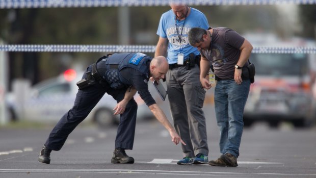 Detectives check the scene where a patrol car came under fire in Hoppers Crossing. 