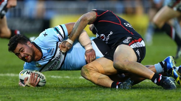 Down he goes: Sharks prop Andrew Fifita is tackled by the Warriors.