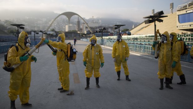 Health workers get ready to spray insecticide in Rio de Janeiro.