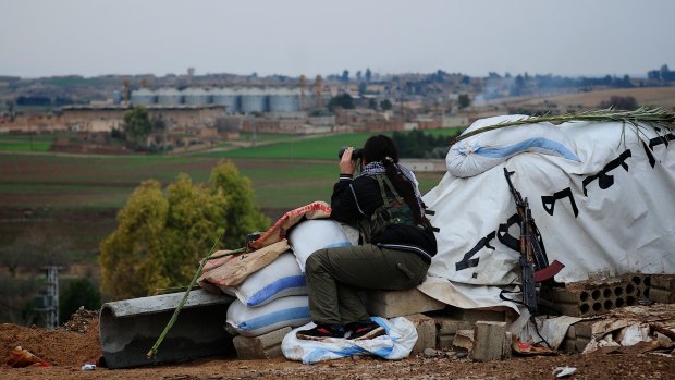 A fighter of the Syriac Security Office, or Sutoro, an Assyrian militia, looks out over territory held by Islamic State militants at a post in Tel Tamer.