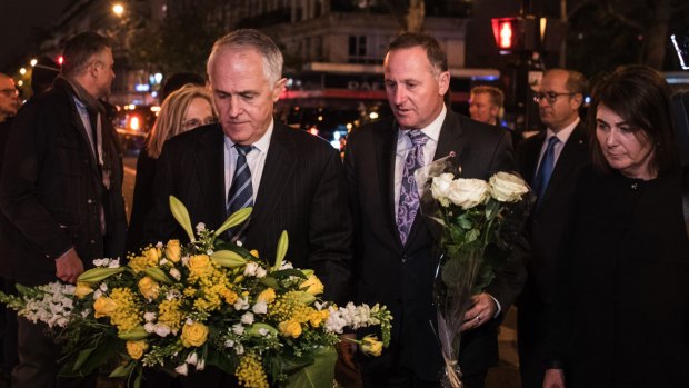 Australian Prime Minister Malcolm Turnbull joins New Zealand's John Key to lay flowers for victims of the Paris terror attacks.