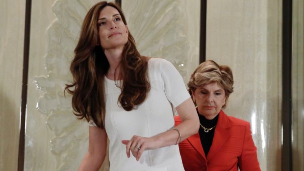 Karena Virginia, left, accompanied by Gloria Allred, arrives for a news conference in New York on Thursday, where she accused the Republican nominee of grabbing her breast at the US Open tennis tournament in 1998.