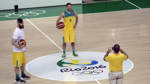 Australia's Matthew Dellavedova (8) poses for a photo with the Rio 2016 logo as teammate Aron Baynes, left, stands by.
