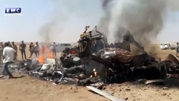 Image purporting to show people gathered around the burning wreckage of a Russian helicopter downed in Syria on Monday.