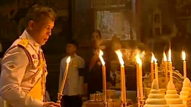 Thailand's new King Maha Vajiralongkorn Bodindradebayavarangkun lights candles for his father at the Grand Palace in December.