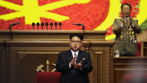 North Korean leader Kim Jong-un, dressed in a suit, applauds at the start of the party congress in Pyongyang on Monday.