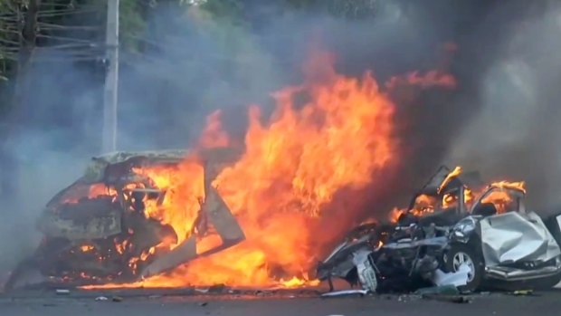 Two vehicles burn after they collided on a highway east of Bangkok on Monday.