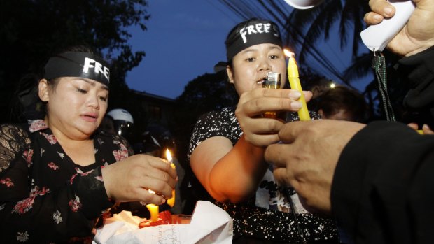 Human rights activists light candles  at Monday's protest in Phnom Penh. Human Rights Watch and Cambodian human rights groups have decried increasing persecution of dissent in the country.