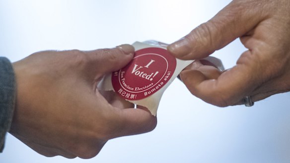A resident collects an "I Voted" sticker after voting in San Francisco.