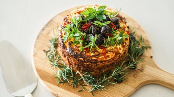 Baked spiced ricotta cake with a central layer of jammy tomatoes.
