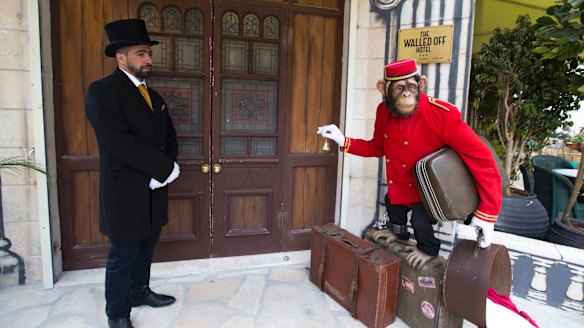 Doorman stands at the entrance of the "The Walled Off Hotel".