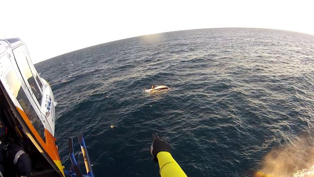 Two 32-year-old men were winched to safety when their boat upturned on the Great Barrier Reef on Thursday morning.