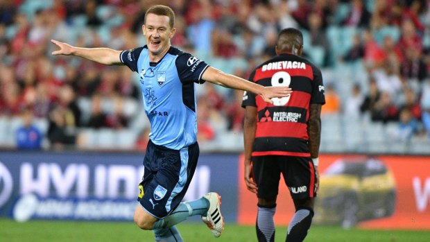 Taking off: Brandon O'Neill celebrates Sydney's fifth goal in the derby.