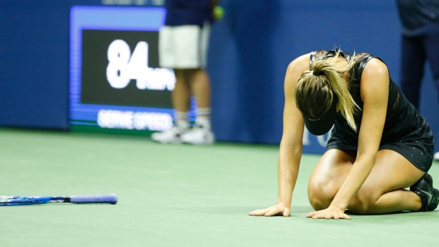 Overwhelmed: Maria Sharapova drops to the court after winning match point.