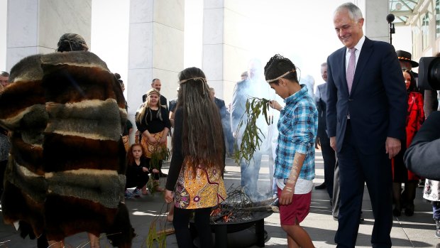 Prime Minister Malcolm Turnbull during the smoking ceremony at the welcome to country ceremony on the forecourt to mark the opening of the 45th Parliament, at Parliament House in Canberra.
