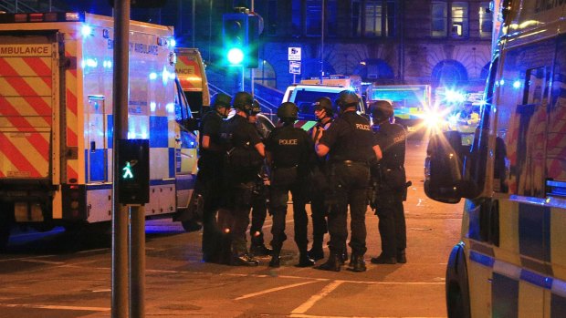 Armed police gather at Manchester Arena after reports of an explosion at the venue during an Ariana Grande gig in Manchester.