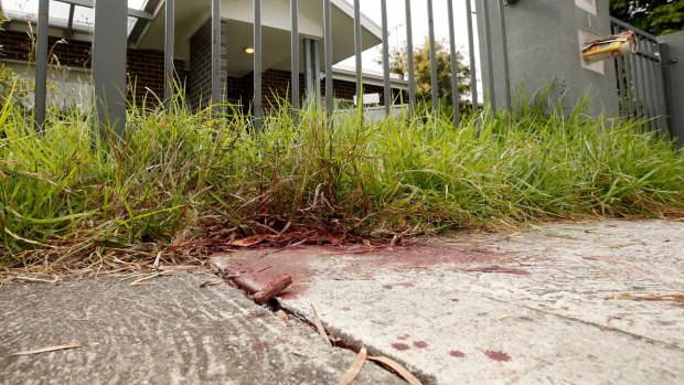 Blood stains on the footpath where a man was run down by a car and attacked by a gang in Braybrook on Saturday night.