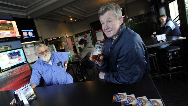 Merv Hall (left) and Billy Hackett lament the fact that men outnumber women in Junee over beers at the Commercial Hotel.