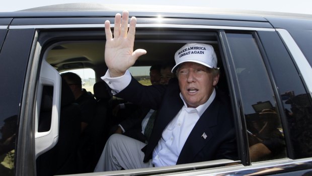 Republican presidential hopeful Donald Trump waves from his vehicle during a tour of the World Trade International Bridge at  the US-Mexico border in Laredo, Texas.