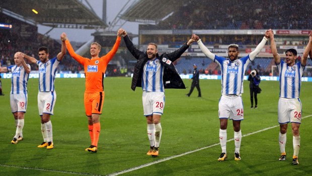 History made: Huddersfield Town's players celebrate victory in front of their home fans.