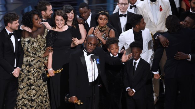 Barry Jenkins, foreground centre, and the Moonlight cast accept the award for best picture.