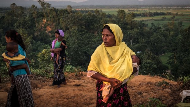 Rohingya women stand on a hill near the border with Myanmar, outside Cox's Bazar, Bangladesh.