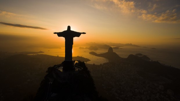 The sun rises behind the Christ the Redeemer statue, above the Guanabara bay in Rio de Janeiro.