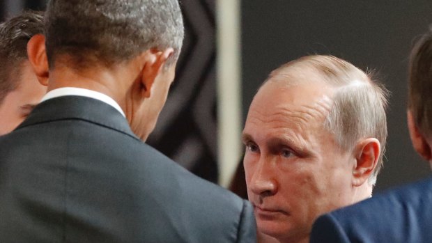 Steely: Vladimir Putin listens to Barack Obama in Lima, Peru.
