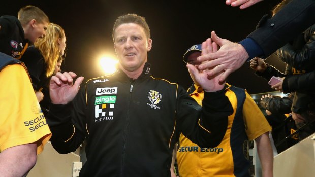 Damien Hardwick high fives fans after his side's win.