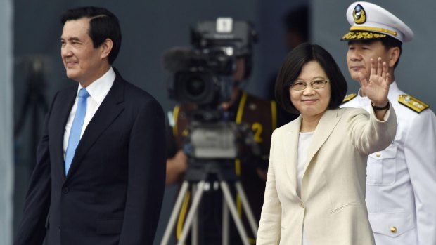 Taiwan's Tsai Ing-wen, right, waves beside her predecessor President Ma Ying-jeou on Friday.