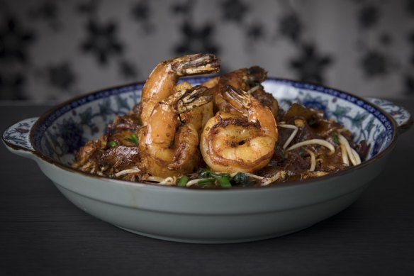 The prawn char kwai teow is tossed over high heat until smoky and soy-blackened.