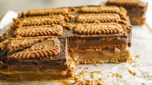 Caramel slice stacked with Biscoff biscuits and spread.