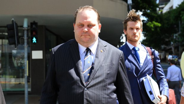 Former Queensland MP Scott Driscoll approaches Brisbane District Court for his sentencing on fraud charges. 