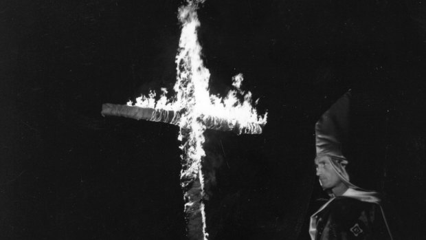 A burning cross dominates a meeting of the American white supremacist movement, the Ku Klux Klan, in Beaufort, South Carolina, in 1965.