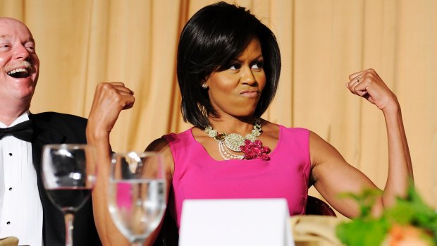 First lady Michelle Obama flexes her arms in response to a joke about her habit of wearing sleeveless dresses during the White House Correspondents' Association Dinner in 2009. 
