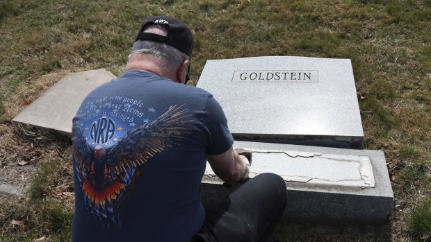 Trump supporter Bob, who declined to give his last name, volunteers his time to repair a damaged headstone in Philadelphia. 