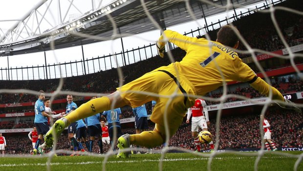 Stoke goalkeeper Asmir Begovic can't keep an Alexis Sanchez free kick out at the Emirates on Sunday.