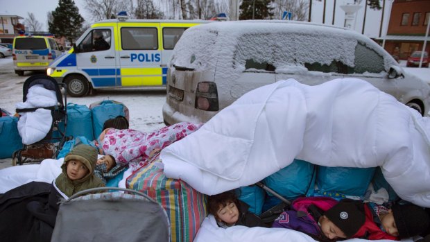 Migrant children from Syria sleep outside the Swedish Migration Board, in Marsta, Sweden. 