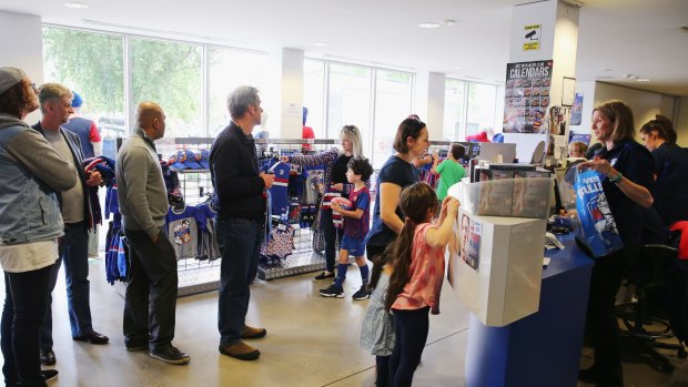 Fans buy merchandise at the club on Monday.