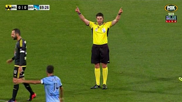 Landmark moment: Referee Shaun Evans signals to the VAR.